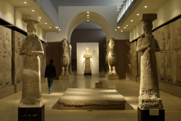 A journalist walks next an Assyrian relief sculpture 585x391 Google Chief Eric Schmidt Announces Documentation of Iraqi Museum Treasures