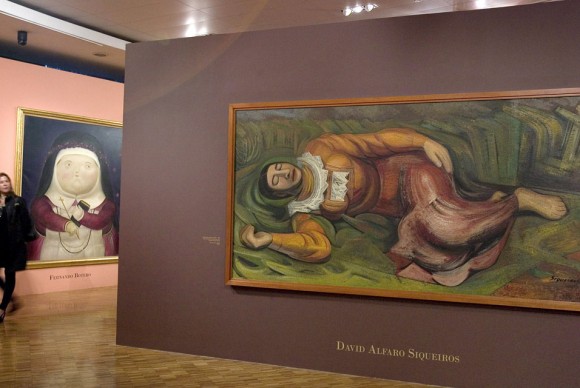 A woman walks by an artwork R entitled Mujer Dormida 1947 by Mexican artist David Alfaro Siqueiros 580x388 Exhibition of Latin American Masters on View at the Museum of Modern Art in Mexico City