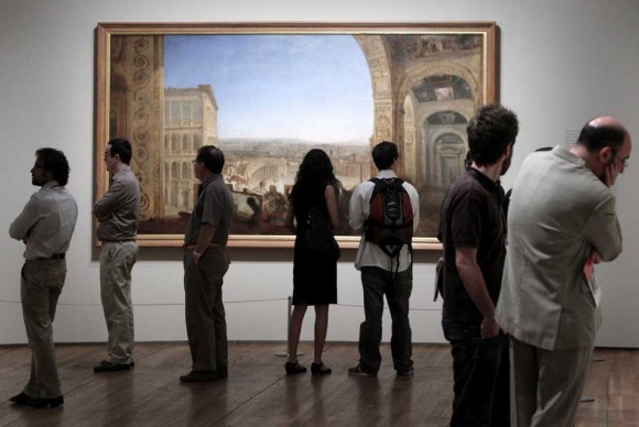 Several people look at the artwork Rome From Vatican by British painter Joseph Mallord William Turner 580x388 SMUs Meadows and Prado Museum Officials Sign Partnership Agreement in Madrid