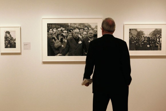 A man looks at a photography exhibit of the work of Henri Cartier Bresson 580x388 SFMOMA Presents Major U.S. Retrospective of Photographer Henri Cartier Bresson