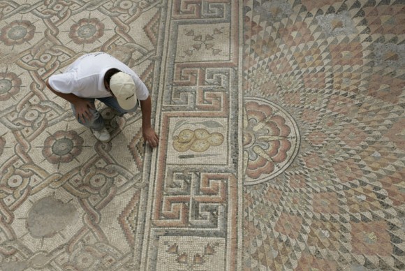 An unidentified man examines part of a mosaic measureing around 9700 square feet 900 square meters 580x388 Jericho Unveils a Massive 1,200 Year Old Carpet Mosaic Measuring Nearly 900 Square Meters