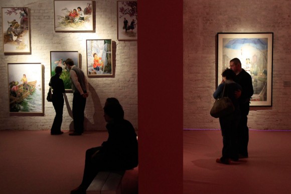 People attend an exhibition of North Korean official art at the Winzavod gallery in Moscow 580x388 Art or Propaganda? North Korea Exhibits a Major Show of Official Art in Moscow