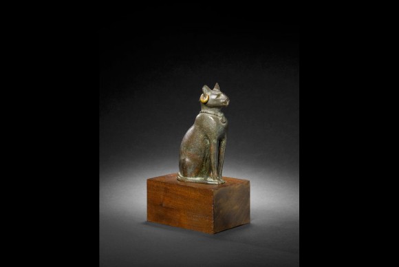 This charming hollow cast bronze cat is shown alert sitting upright with the tail curled to the right side 580x388 Two Thousand Year Old Cat Still Looks Cool in Gold Earrings at Bonhams Sale of Antiquities