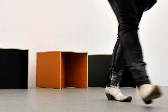 A woman walks past furniture by US artist Donald Judd 580x388 Donald Judd: A Good Chair is a Good Chair at the International Design Museum in Munich