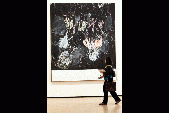 A visitor passes by an artwork from a series entitled Mrs Lenin and the Nightingale by German artist Georg Baselitz 580x388 Guggenheim Museum in Bilbao shows Georg Baselitz Mrs. Lenin and the Nightingale
