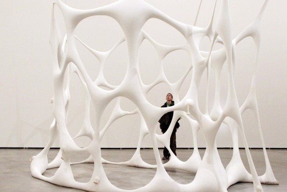 A visitor looks at the sculpture Globulocell by Brazilian artist Ernesto Neto 580x388 Art from the Collections of la Caixa Foundation and MACBA on view at the Guggenheim