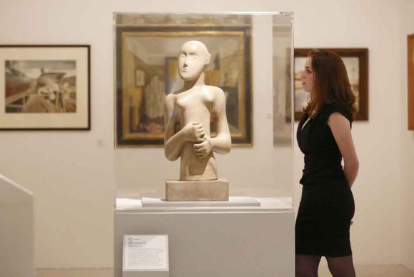 A gallery assistant looks at a work by British Sculptor Henry Moore entitled Girl 1931 580x388 The Royal College of Art celebrates 175 years with major historic exhibition