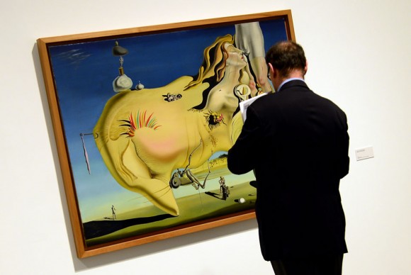 A man looks at a painting entitled The Great Masturbator 1929 by Spanish surrealist artist Salvador Dali 580x388 Major retrospective of works by Salvador Dali opens at Reina Sofia Museum in Madrid