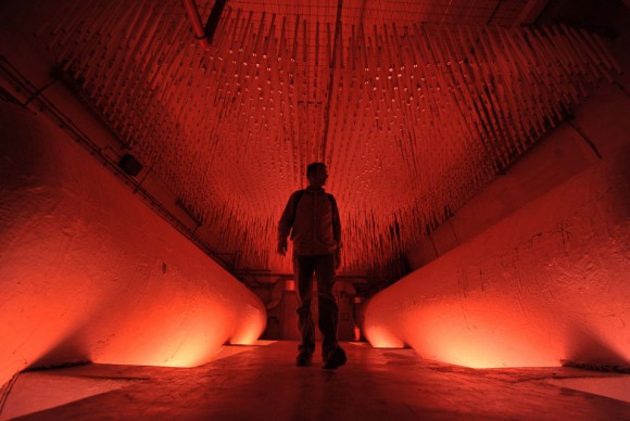A man looks at an art installation set up in a nuclear shelter in Konjic on May 11 2011 580x388 Cold War bunker in Bosnia revived by modern art