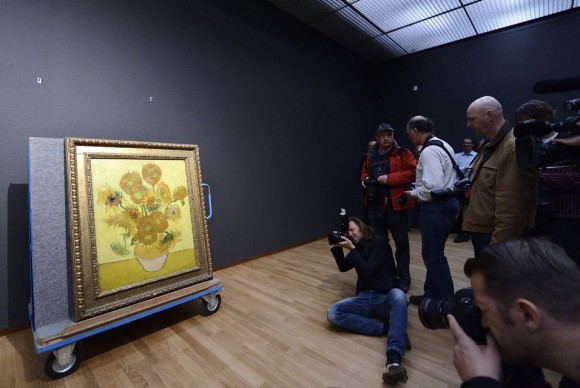 Photographers shoot pictures of the famous painting Sunflowers of painter Vincent Van Gogh 580x388 Van Goghs back home in renewed Amsterdam museum ahead of its reopening next week