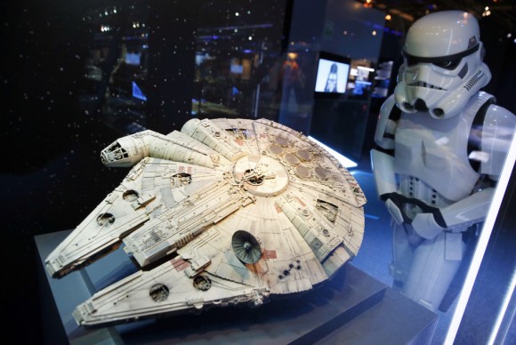 A performer dressed as a stormtrooper character R looks at a model of the Millenium Falcon starship 580x388 Cité du Cinéma in Paris offers an interactive journey into the world of Star Wars