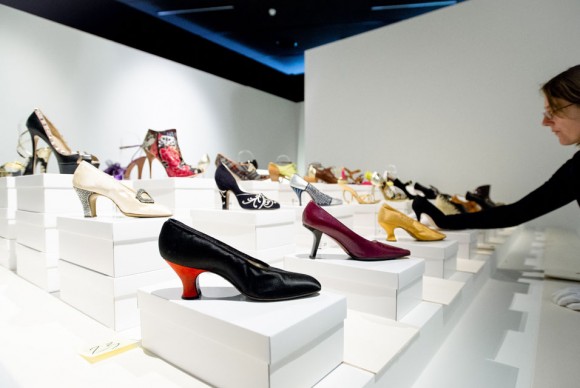 A woman places shoes as part of the SHOES exhibition at the Kunsthal in Rotterdam 580x388 Kunsthal in Rotterdam opens exhibition on the astonishing story of womens shoe design