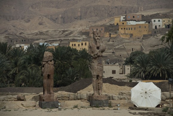 A picture taken on March 23 2014 shows newly displayed statues of pharaoh Amenhotep III in Egypts 580x388 After weathering severe damage for centuries, two restored colossal pharaoh statues unveiled in Egypt
